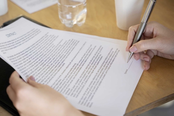 high-angle-woman-signing-document